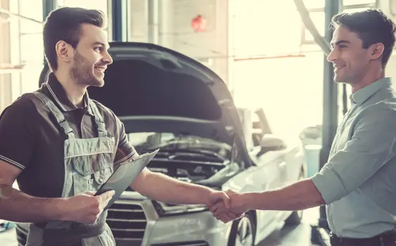 Auto repair technician shaking hands with customer at Rowan Tire & Auto in Belleville IL
